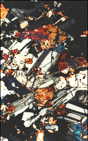 A thin section of a sample when viewed under a microscope, shows the mineral grains, their sizes and shapes, and how they fit together within the rock