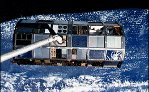 Long Duration Exposure Facility (LDEF) being retrieved by Space Shuttle after 5.7 years in orbit.